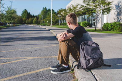 Teen outside school depicting school refusal program